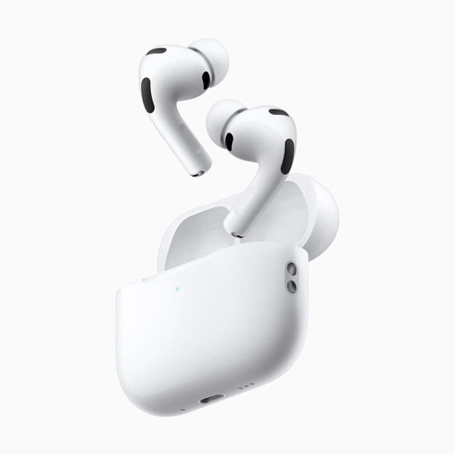 AirPods Pro with their open charging case on a light background